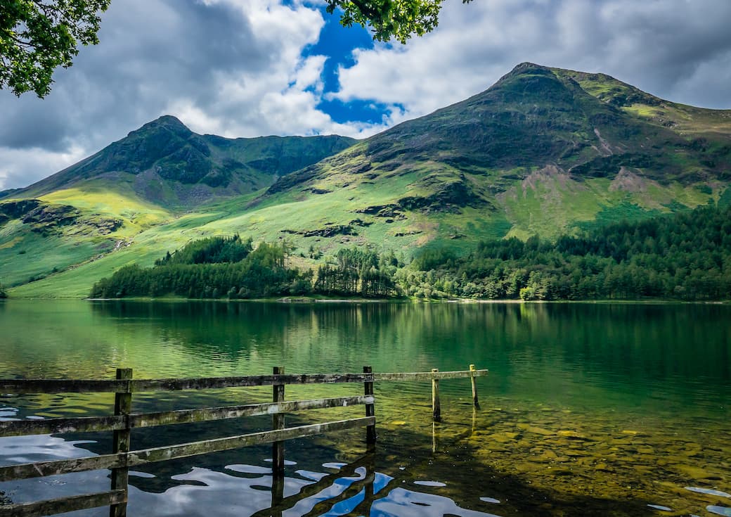 Mountains and water with blue sky and clouds_Buttermere in the Lake District_The best UK holiday destinations for families