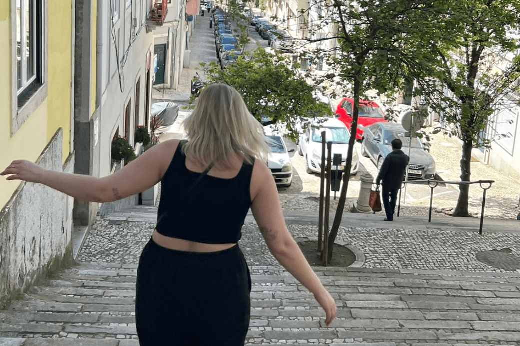 Young woman on stone steps in Lisbon.